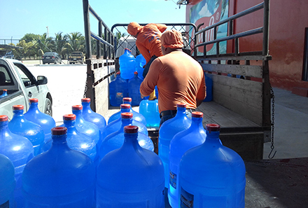 Unloading water in Santa Elena Heifer Ecuador Earthquake Recovery