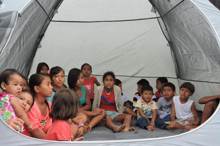 Children taking refuge in a tent distributed by Heifer Ecuador. children taking refuge in a tent