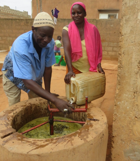 Mamadou and Yacine feed their biogas digester. Mamadou and Yacine feed their biogas digester.