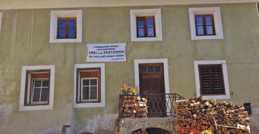 Residents came together to protest pesticide use. Banner protesting pesticides hung under a window.